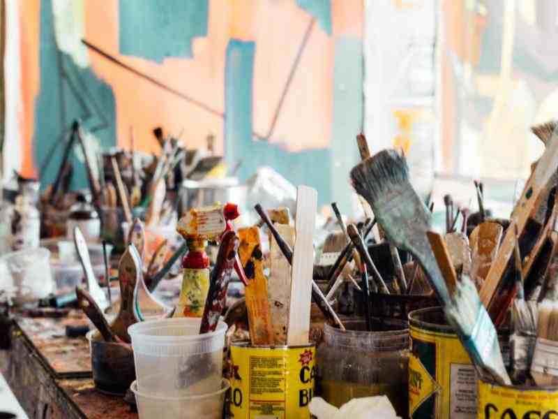 table full of painting brushes