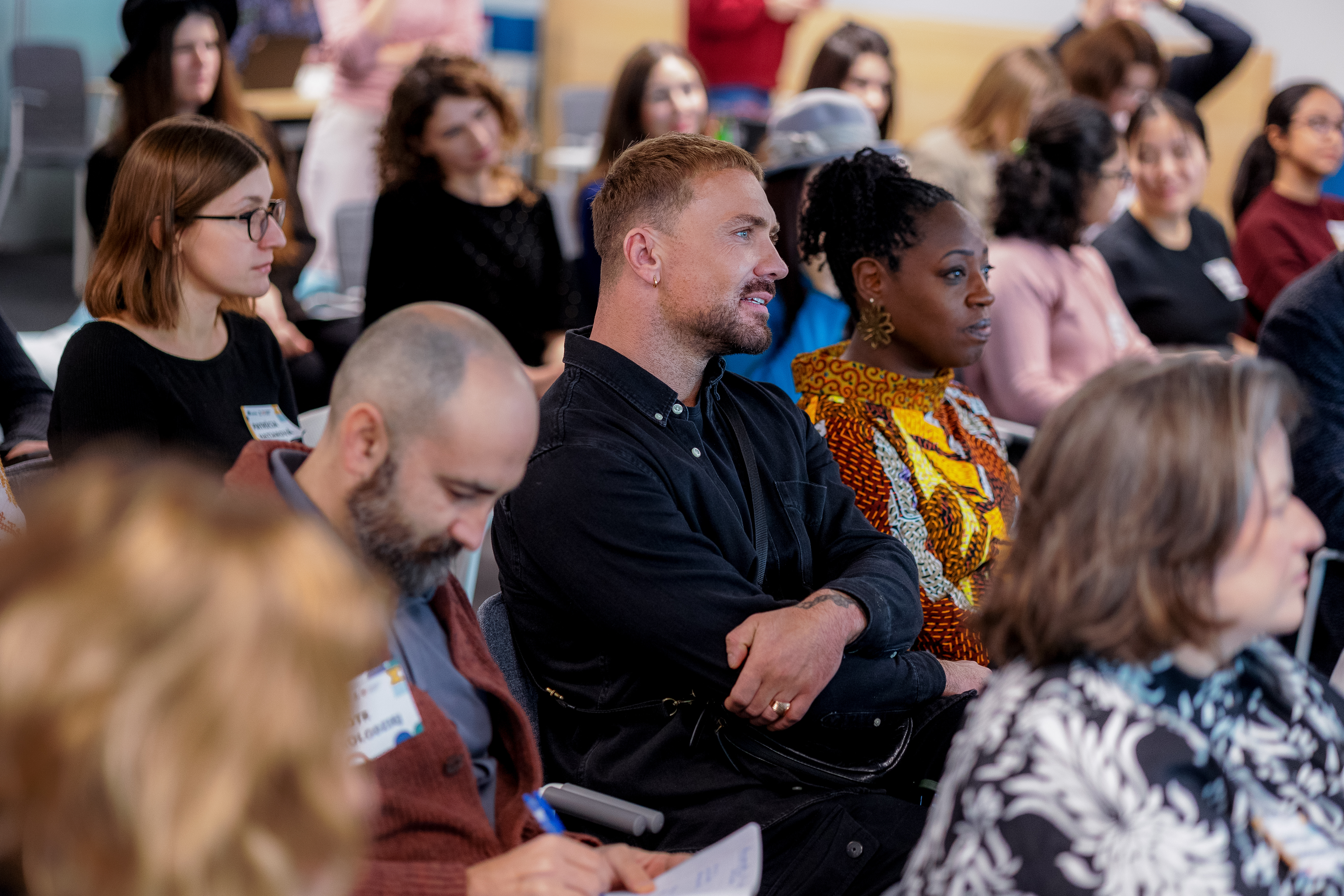 A group of people sitting in the audience