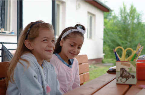 two girls sitting at the table