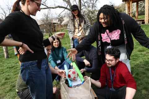 A group of young people working on a DIY divice