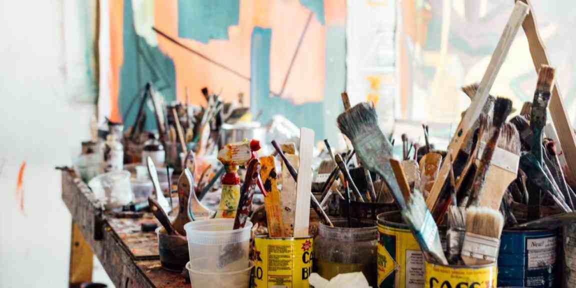 table full of painting brushes