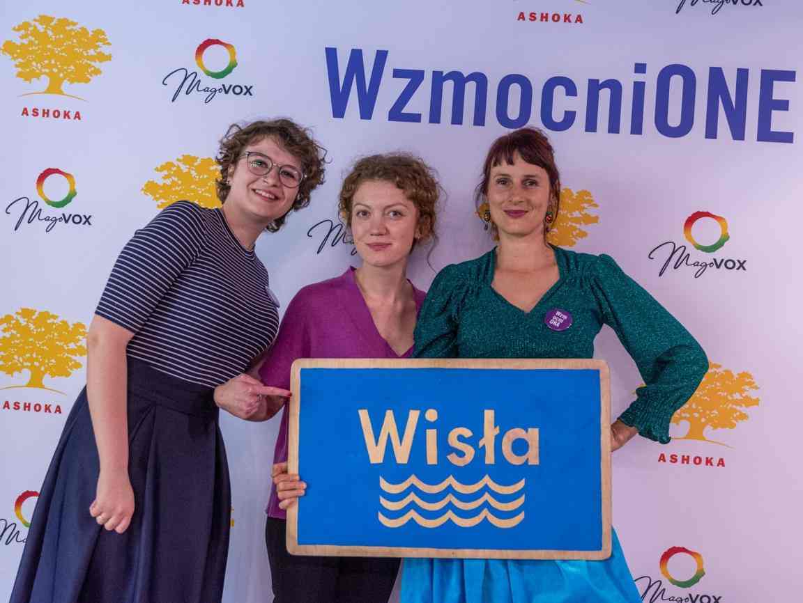 3 smiling women on the wall with logos of Ashoka and Magovox