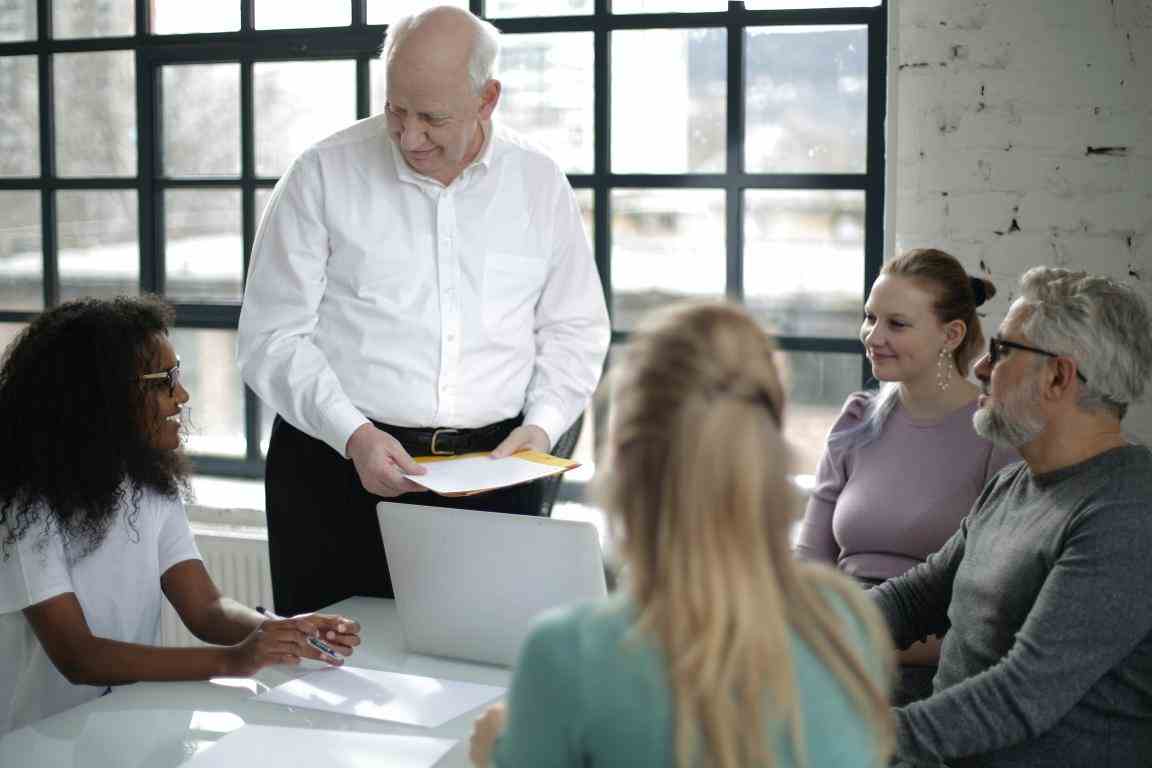 Smiling multiethnic coworkers discussing project in office