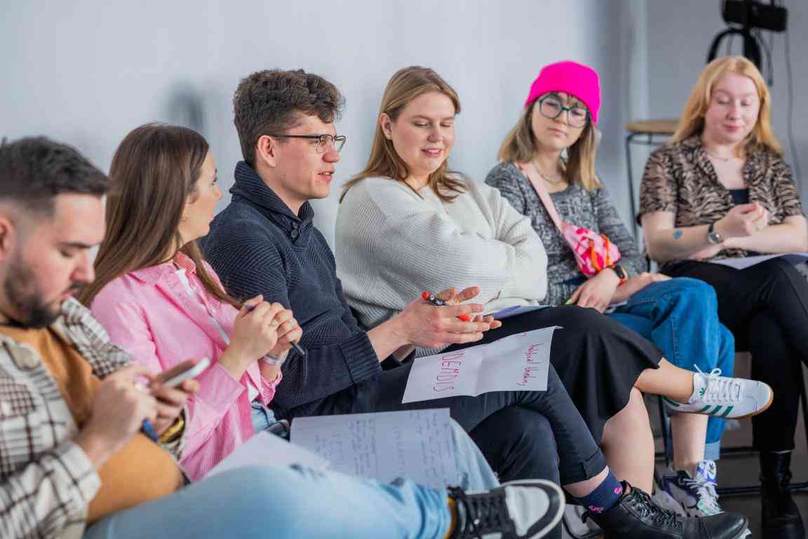 6 young people sitting in a room