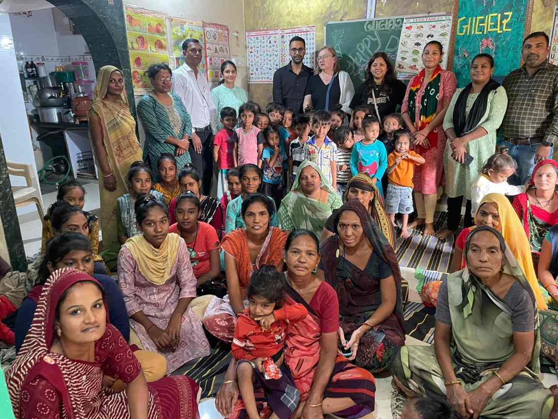 IKEA co-workers with women and children from the communities they work with. Photo courtesy of Saath team.