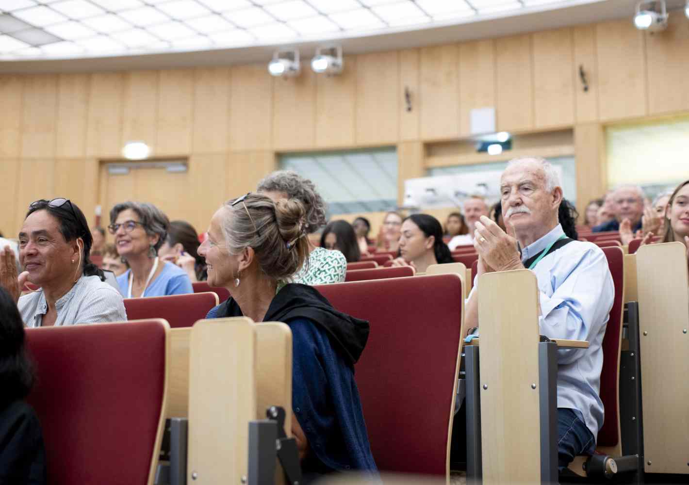 participants applauding in a conference room