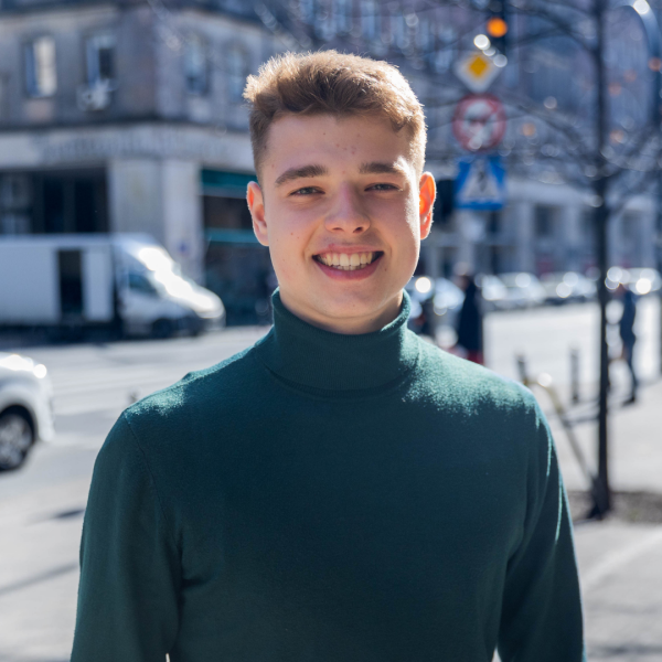 Young man standing on the street, smiling