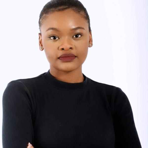Photo of Tsholofelo Diale, staff member with Ashoka Africa. Person with short black hair and dark olive skin smiling at the camera. Dressed in a professional black long sleeved shirt