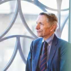 Bill Drayton by window facing left