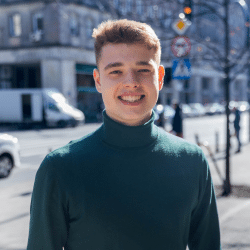 Young man standing on the street, smiling