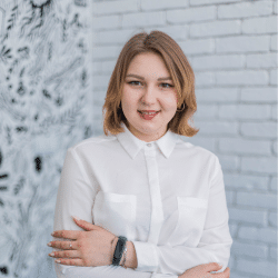 Young woman in white shirt standing inside