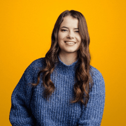 Young woman with long hair smilin, orange background