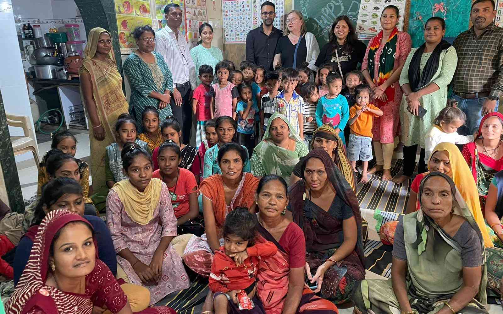 IKEA co-workers with women and children from the communities they work with. Photo courtesy of Saath team.