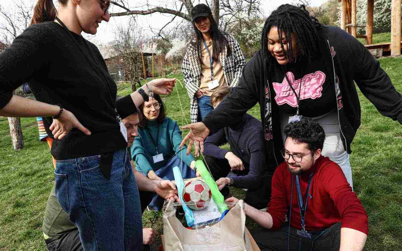 A group of young people working on a DIY divice