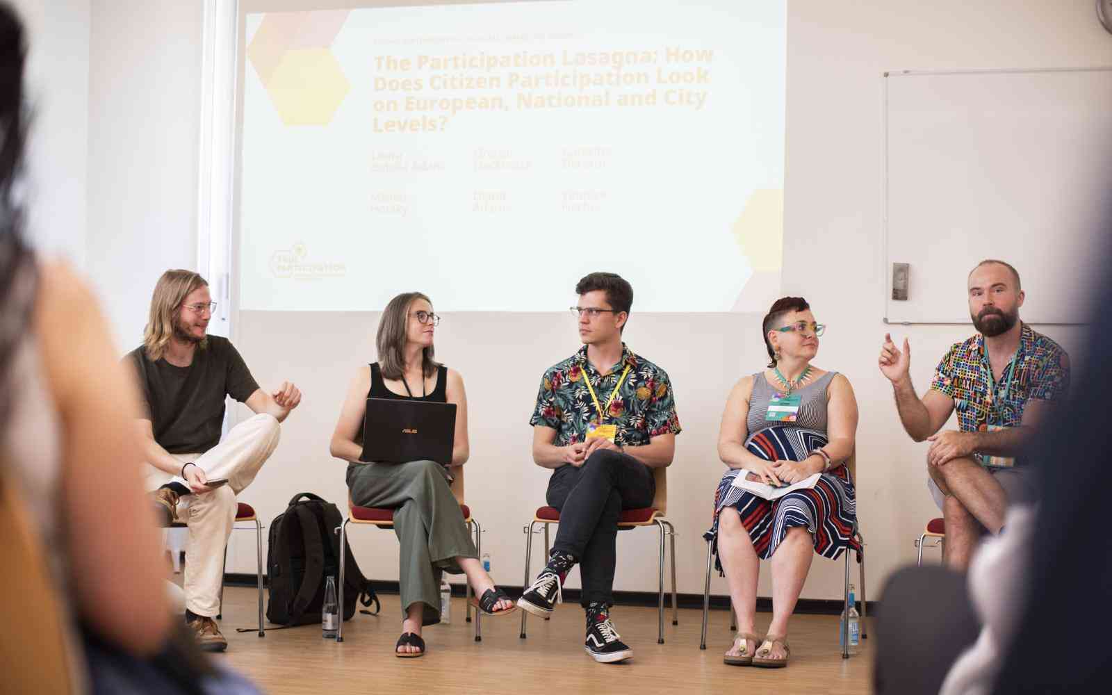 5 people sitting during panel discussion