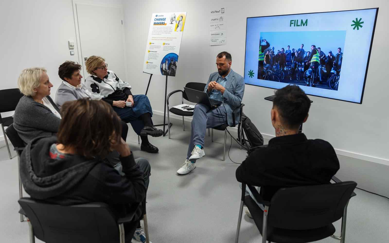 A grop of people listening to presentation