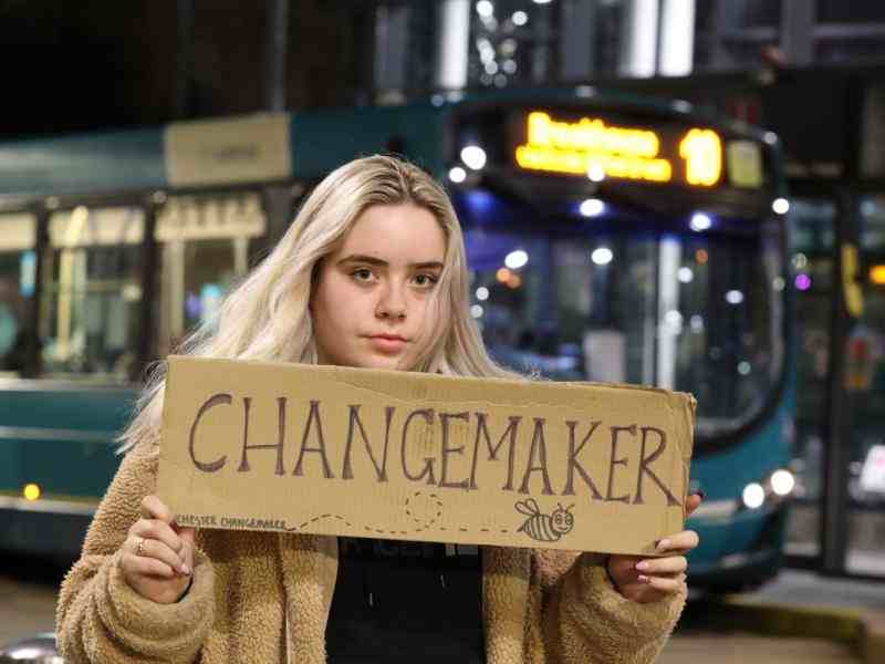Liv holding a sign which says Changemaker