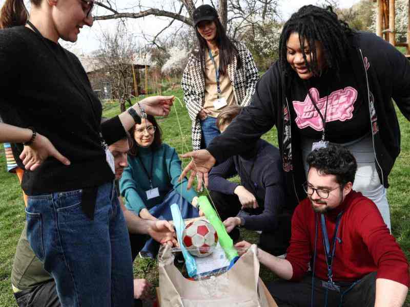 A group of young people working on a DIY divice