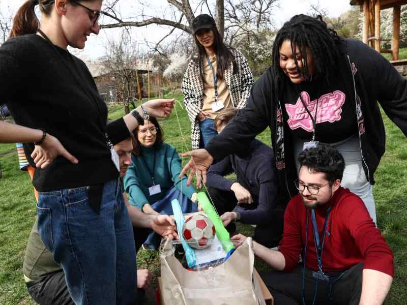 A group of young people working on a DIY divice