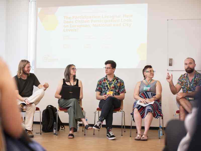 5 people sitting during panel discussion